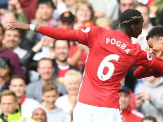 Manchester United's French midfielder Paul Pogba (L) and Manchester United's English midfielder Jesse Lingard (R) celebrate after Pogba scored their fourth goal during the English Premier League football match between Manchester United and Leicester City at Old Trafford in Manchester, north west England, on September 24, 2016. / AFP PHOTO / ANTHONY DEVLIN / RESTRICTED TO EDITORIAL USE. No use with unauthorized audio, video, data, fixture lists, club/league logos or 'live' services. Online in-match use limited to 75 images, no video emulation. No use in betting, games or single club/league/player publications. /