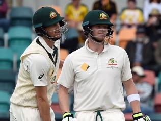 Australia's captain Steven Smith (R) with teammate Adam Voges wait for the third umpire's decision on his catch behind an appeal off the bowling by South Africa's Kyle Abbott (not pictured) on the fourth day of play in the second Test cricket match between Australia and South Africa in Hobart on November 15, 2016. / AFP PHOTO / SAEED KHAN / --IMAGE RESTRICTED TO EDITORIAL USE - STRICTLY NO COMMERCIAL USE--