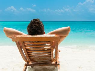 Man relaxing on beach, ocean view, Maldives island