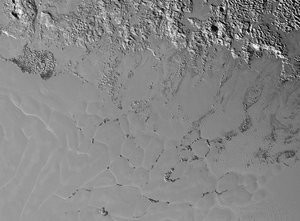 The nitrogen ice glaciers on Pluto appear to carry an intriguing cargo: numerous, isolated hills that may be fragments of water ice from Pluto’s surrounding uplands. These hills individually measure one to several miles or kilometers across, according to images and data from NASA’s New Horizons mission.