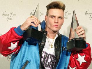 Vanilla Ice displays his awards he won in the rock and rap catagories at the American Music Awards in this Jan. 28, 1991 file photo. The 36-year-old rap performer, who had a '90s hit with "Ice Ice Baby," called animal control officials Wednesday to report that a wallaroo and a goat found wandering around Port St. Luciem Florida belong to him. (AP Photo/Reed Saxon)