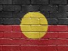 Flag of Aborigines on brick wall Aboriginal indigenous flag