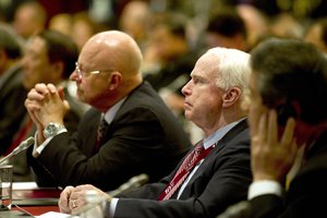 File - U.S. Sen. John McCain of Arizona, center, and Director of National Intelligence James R. Clapper Jr., left, listen as U.S. Defense Secretary Robert M. Gates addresses the audience during the Shangri-La Dialogue security summit at the Shangri-La Hotel in Singapore, June 4, 2011.