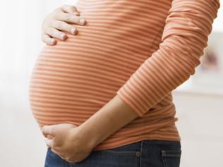 Beautiful young pregnant woman smiling