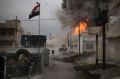 A car bomb explodes next to Iraqi Special Forces armoured vehicles as they advance towards Mosul.