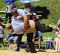 A wrestling high. To win, one wrestler must force his opponent onto the floor, and pin his shoulders to the sawdust. 