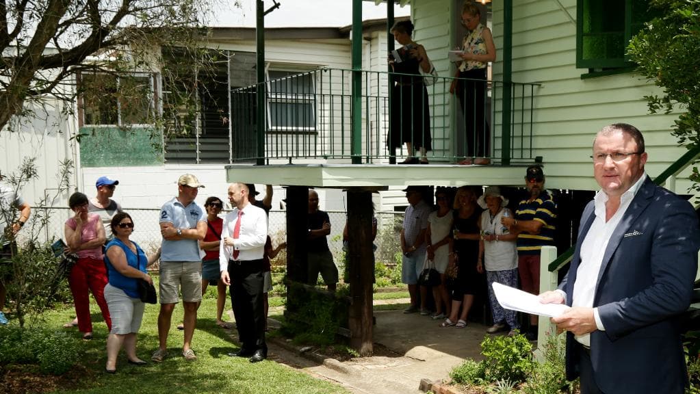 Place Estate Agents’ Peter Burgin prepares to call the auction of 16 Macaulay St, Coorparoo. Picture: Mark Calleja