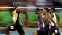 Smile for the camera: Usain Bolt competes in the men's 100m semi-final.