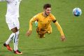 Firing wide: Mathew Leckie's header against Iraq misses the target.