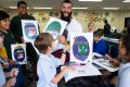 Artist Mulga fires up young imaginations during a workshop for primary school students at Liverpool Library.