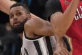 Patty Mills tangles with Anthony Davis.