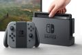The Switch console is pictured here in its TV dock. The left and right controller modules, pictured here attached to the ...