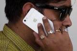 An Indian man talks on his iPhone in New Delhi, India, Wednesday, May 18, 2016. Apple has announced that it will set up ...