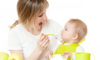 Mother feeding puree to baby