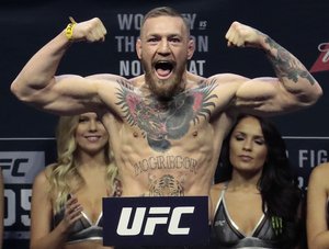 Conor McGregor stands on a scale during the weigh-in event for his fight against Eddie Alvarez in UFC 205 mixed martial arts, Friday, Nov. 11, 2016, at Madison Square Garden in New York.