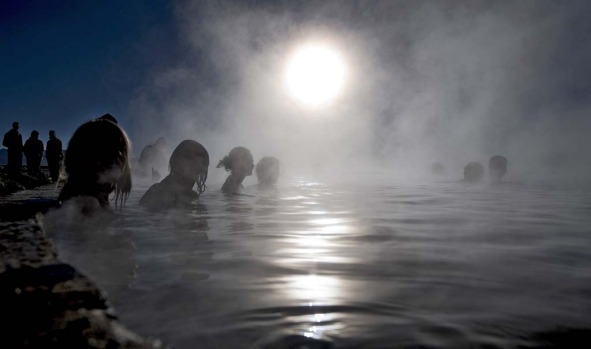 Tourists bathe in hot springs near the small village of Agua Brava, more than 4000 meters above sea level, in the Uyuni ...