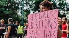 A woman holds a sign at a Brisbane pro-choice rally in May.