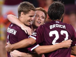 Thomas Kristensen of the Brisbane Roar (left) celebrates scoring a goal during their round 7 A-League game against Sydney FC at Suncorp Stadium in Brisbane, Saturday, Nov. 19, 2016. (AAP Image/Dan Peled) NO ARCHIVING, EDITORIAL USE ONLY