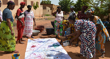  A group of women sprinkle dye on cloth as part of a job creation scheme in Bamako, Mali. © OHCHR/Kaylois Henry