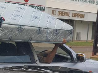 A driver has been spotted holding onto a mattress to keep it on top of his car. PICTURE: Supplied