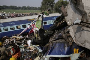 Rescuers work on the site of a train derailment accident in Kanpur Dehat, India, Sunday, Nov. 20, 2016. Many were killed Sunday when 14 coaches of an overnight passenger train rolled off the track in northern India.