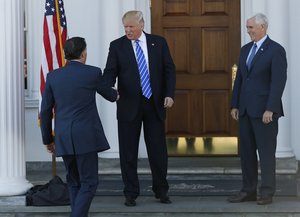 President-elect Donald Trump, center, and Vice President-elect Mike Pence, right, greet Mitt Romney, left, as he arrives at Trump National Golf Club Bedminster clubhouse in Bedminster, N.J.