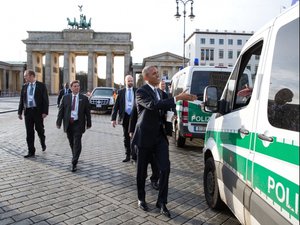 President Barack Obama greets local police as he walks by the Brandenburg Gate from the U.S. Embassy to his hotel in Berlin, Germany, Nov. 17, 2016.