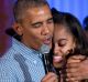 US President Barack Obama hugs and sings "Happy Birthday" to his daughter Malia during Independence Day celebrations in ...