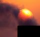 Smoke rises from an oil pipe at sunset in the desert oil field of Sakhir, Bahrain. 