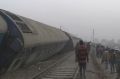 People gather at the site of a train accident near Pukhrayan, about 270 kilometers from Allahabad, Sunday.