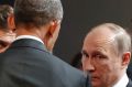 US President Barack Obama, left, talks with Russia's President Vladimir Putin, centre, and Kremlin foreign affairs ...