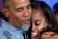 US President Barack Obama hugs and sings "Happy Birthday" to his daughter Malia during Independence Day celebrations in ...