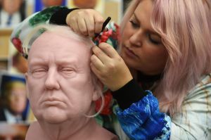 Sophie Crudgington inserts Yak hairs onto an unfinished wax figure of President-elect Donald Trump.