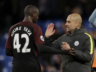 Manchester City's Yaya Toure, who scored both their goals, celebrates with his head coach Pep Guardiola after the English Premier League soccer match between Crystal Palace and Manchester City at Selhurst Park stadium in London, Saturday, Nov. 19, 2016. (AP Photo/Matt Dunham)