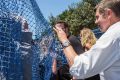 A protester attempts to net Premier Mike Baird in Ballina after the instalment of the first shark net on the North Coast.