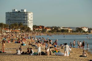 People enjoy the sun at St Kilda beach on Sunday.