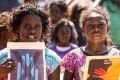 Children reinforce the "No More" message in their march. 