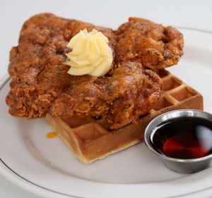 Fried chicken and waffle with whipped butter and bourbon-spiked maple syrup.