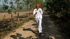 Dharam Pal Singh, a herder who regularly runs and claims to be 119 years old, trains on a dirt road near his home in the ...