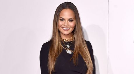 Chrissy Teigen is sorry for showing you her 'hooha' in pelvic bone baring dress at the AMAs on Sunday.