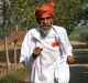 Dharam Pal Singh, a herder who regularly runs and claims to be 119 years old, trains on a dirt road near his home in the ...