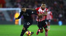 SOUTHAMPTON, ENGLAND - NOVEMBER 19: Roberto Firmino of Liverpool (L) is pulled back by Ryan Bertrand of Southampton (R) ...