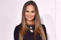 Chrissy Teigen is sorry for showing you her 'hooha' in pelvic bone baring dress at the AMAs on Sunday.