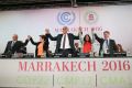 UN climate chief Patricia Espinosa, second left, and Morocco's Foreign Minister Salaheddine Mezouar, centre, celebrate ...