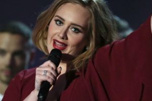 FILE - In this Feb. 24, 2016 file photo, Adele holds the Best British Female Solo Artist award onstage at the Brit ...