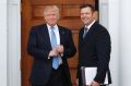 Plan in view: Kris Kobach holds his meeting papers.