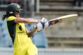 Ellyse Perry hits a four.