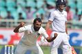 Mohammed Shami celebrates the dismissal of England's Joe Root, right. 