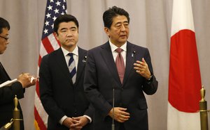 Japanese Prime Minister Shinzo Abe, right, speaks to members of the press after meeting with President-elect Donald Trump, Thursday, Nov. 17, 2016, in New York.