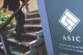 An ASIC staffer has been charged with money laundering offences.